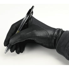 gloved hand writing with a pen