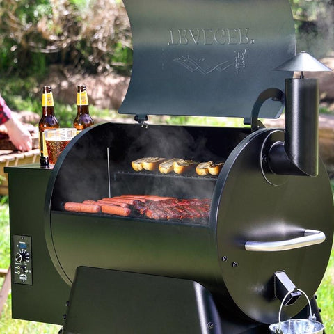 Traeger Pro Series 22 Bronze Pellet Grill in use grilling hot dogs and other food