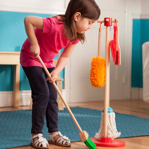child with toy broom