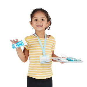 Girl Smiling and Holding Dental Accessories