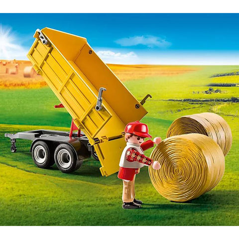 Man Rolling Hay Bale