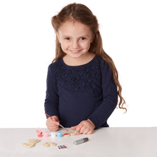 girl using magnet decorating supplies