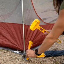 Person Hammering Tent Peg