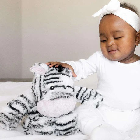 child playing with Warmies Zebra