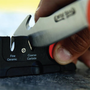 Outdoor Edge Edge-X two-stage Knife Sharpener in use sharpening a knife blade