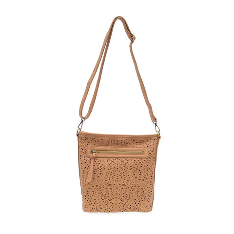 Joy Susan lazer cut eyelet bucket crossbody bag in tan showing shoulder strap