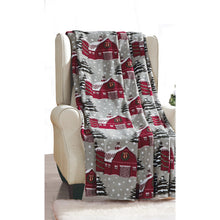 Plush Snowy Barn Christmas throw blanket on a chair