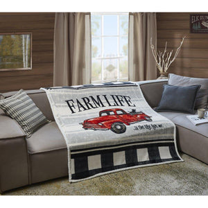 Black and white plaid throw with a red truck