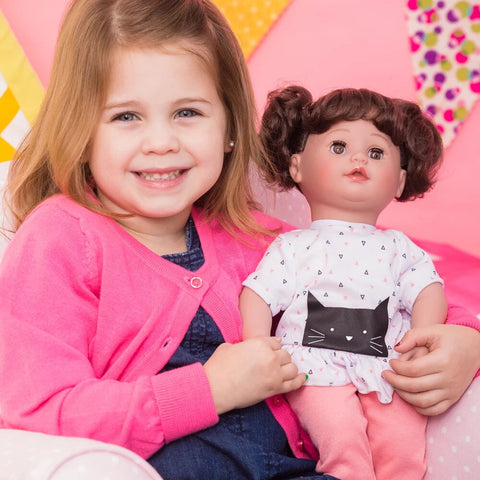 Little girl holding doll