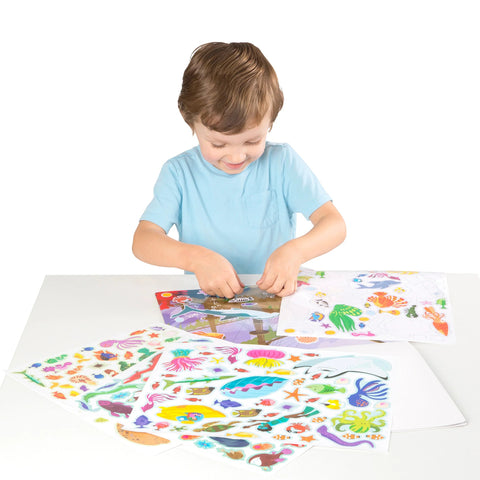 Child playing with sticker pad