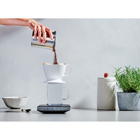 Adding coffee grinds