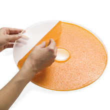 Person peeling food off drying trays