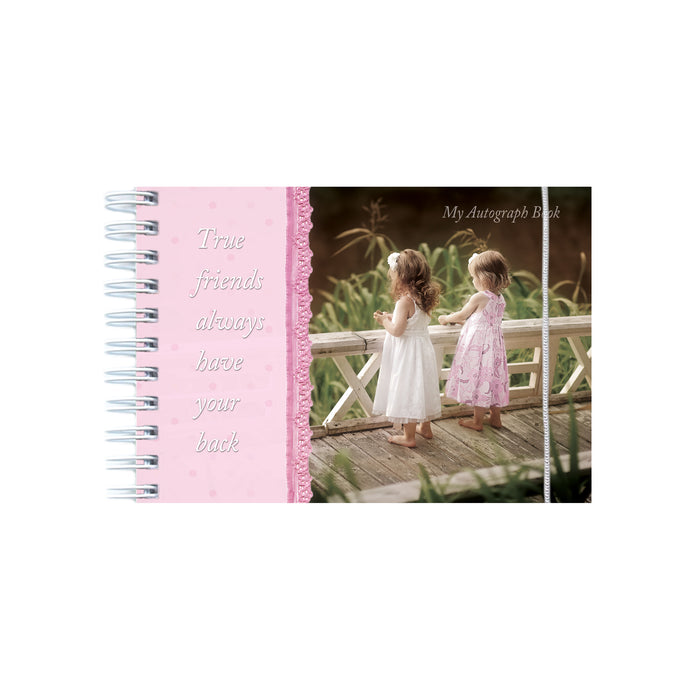 Autograph book with photo of two girls standing on a bridge.