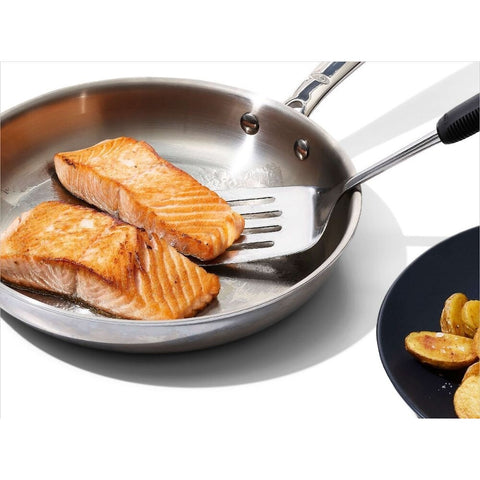 Stainless Steel Turner 11283300 being used for flipping salmon in a frying pan