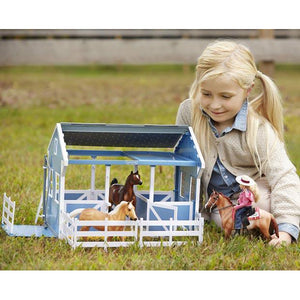 Girl playing with barn.