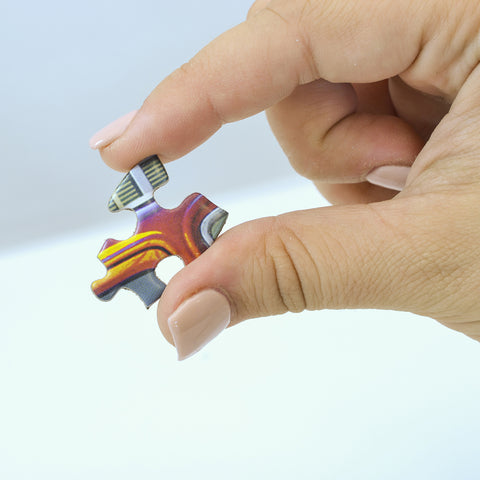 Hand holding puzzle piece to show size
