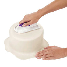 Decorating a cake with fondant