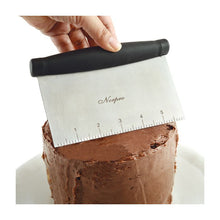 Using Norpro scraper to smooth icing on cake