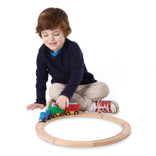 Boy using train set