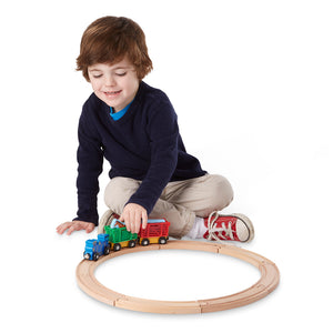 Boy using train set