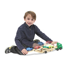 Boy playing with car carrier toy