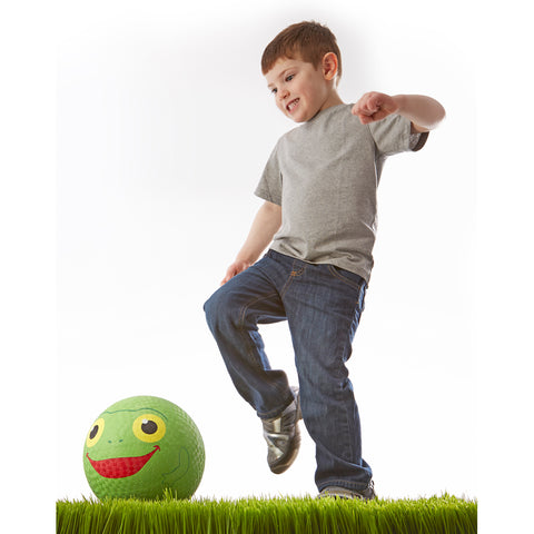 Boy playing with kickball.