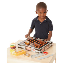 Boy playing with grilling set