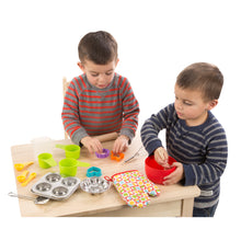 Children playing with baking set