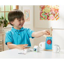 Child using toy coffee set.