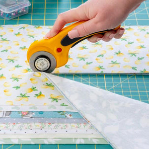 Woman Cutting Fabric with Rotary Cutter