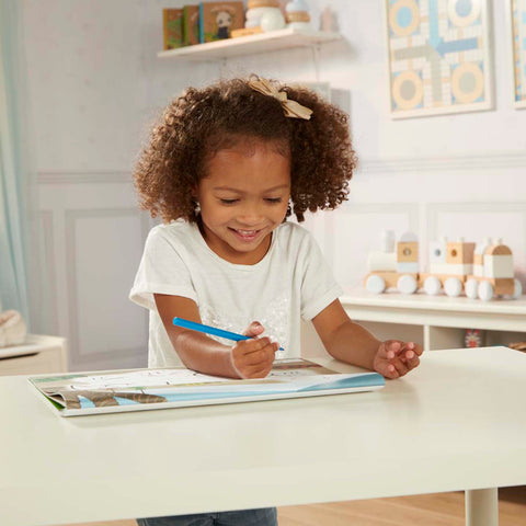 Girl marking dot-to-dot book