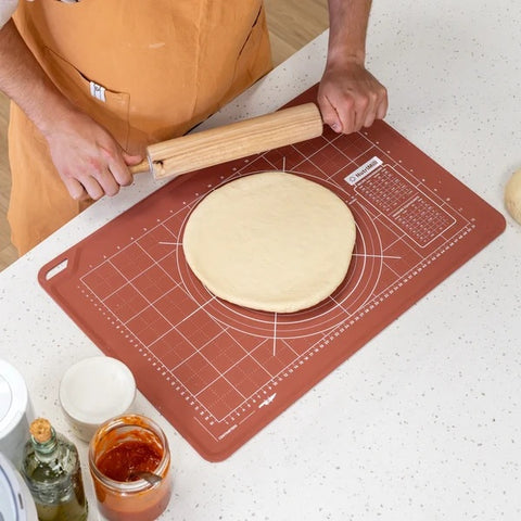 Silicone Dough Mats 950310 being used to roll pizza dough on