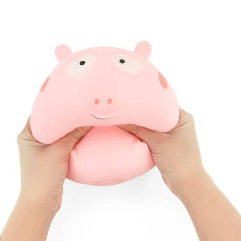 Squeezing thet The Big Squij Pig squishy toy