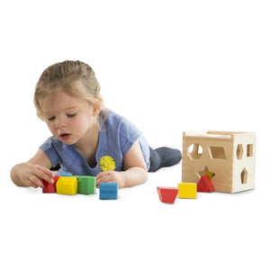 Shape sorting cube. Child playing.