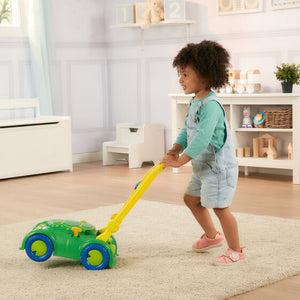 child pushing toy mower