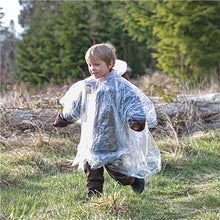 child running outside wearing poncho