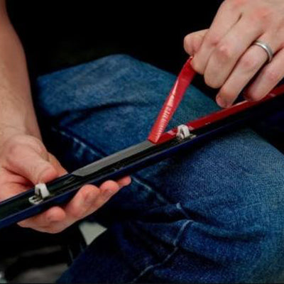 Man Removing Lining from Tape