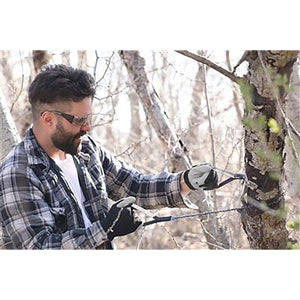 man sawing tree with Pocket Chainsaw 2227