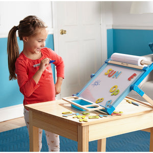 girl using table top easel dry erase board