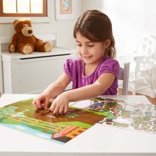 child placing sticker on reusable farm set
