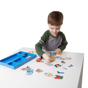 boy playing with magnetic dress up figure