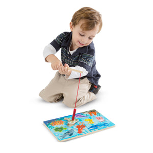 boy with magnetic fishing puzzle