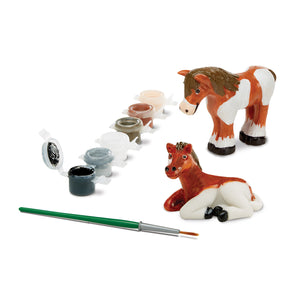 horse figurine set and paints in use