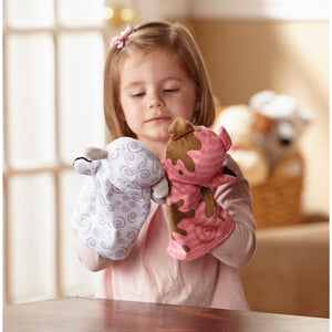 girl with farm friends sheep and pig hand puppets