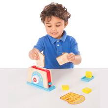 child with play wooden toaster set