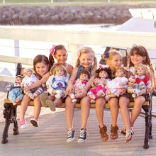 Girls holding Adora dolls