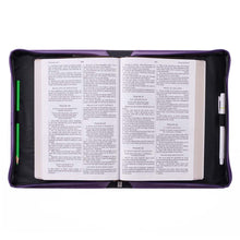 open Bible cover with Bible and pens inside