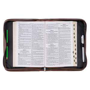 Bible cover open with Bible and pens inside