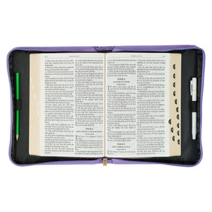 open Bible cover with Bible and pens inside
