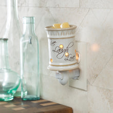 Wax warmer that plugs into the wall.